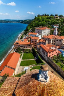 View from the bell tower over Piran with city walls and castle, harbour town of Piran on the
