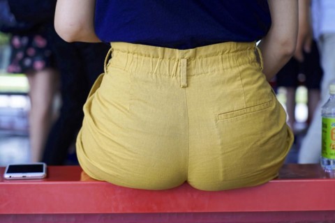 New Summer Palace, Beijing, China, Asia, A person sits on a red stripe, dressed in yellow trousers,