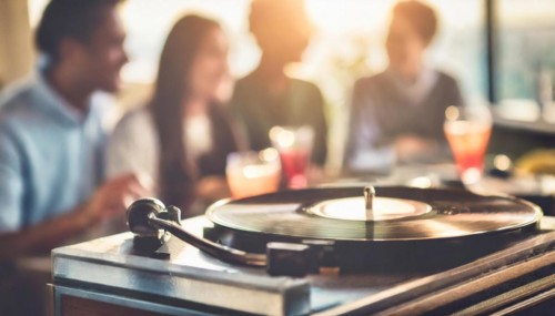 An intimate social event with a group of people around a turntable playing a vinyl record, AI