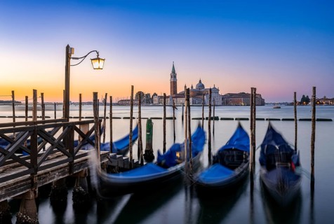 Venetian gondolas, boat dock at St Mark's Square, church of San Giorgio Maggiore in the background,