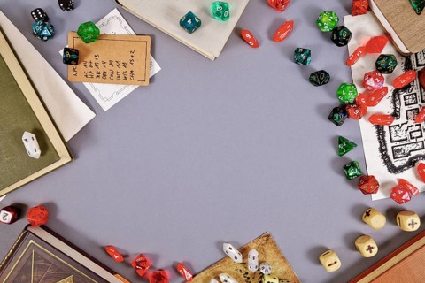 Tabletop role playing flat lay background with RPG dices, rule books, dungeon map and copy space in