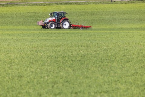 Farmer fertilising his field with a tractor, Neidlingen, Baden-Wuerttemberg, Germany, Europe