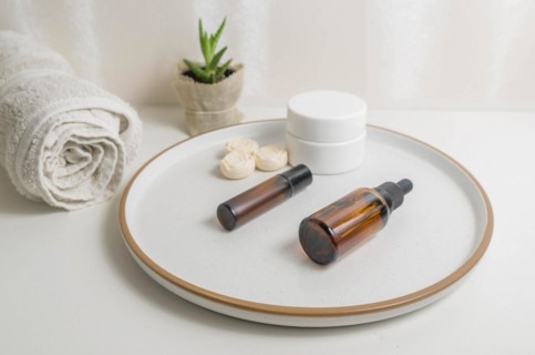 Cosmetic packaging. Set of different cosmetics on plate with decoration. Skin care concept
