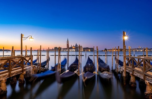 Venetian gondolas, boat dock at St Mark's Square, church of San Giorgio Maggiore in the background,
