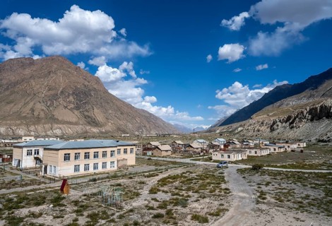 View of houses still inhabited in the ghost town of Engilchek, mountain landscape, Tian Shan,
