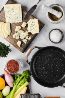 Top view of ingredients for risotto with pink rice, pear and blue cheese