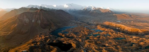 Aerial view, high mountain landscape with glacial moraines and mountain lakes, behind Pik Lenin,