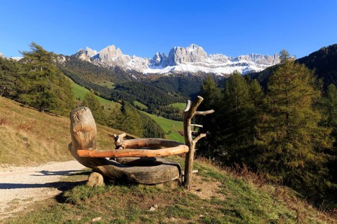 Mountain view from a rustic wooden bench on a sunny autumn day, Italy, TAlto Adige, Bolzano