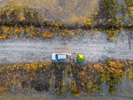 Camping with green tent and off-road vehicle Toyota Land Cruiser, top down shot, Toktogul,