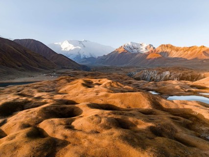 Aerial view, high mountain landscape with glacial moraines and mountain lakes, behind Pik Lenin,