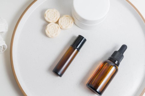 Cosmetic packaging. Set of different cosmetics on plate with decoration. Skin care concept