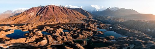 Aerial view, high mountain landscape with glacial moraines and mountain lakes, behind Pik Lenin,