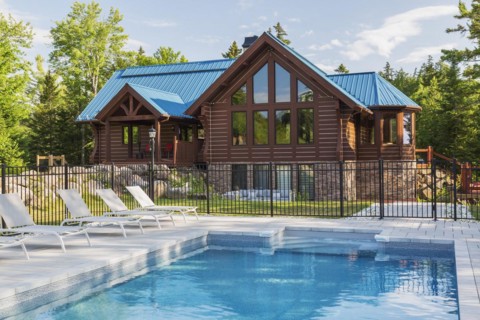 In-ground salt water swimming pool and brown stained milled Eastern white pine timber and flat log