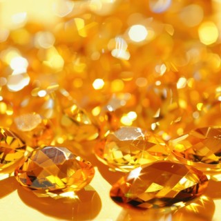 Seamless pattern background of shimmering citrines on a warm yellow surface AI generated