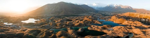 Aerial view, high mountain landscape with glacial moraines and mountain lakes, behind Pik Lenin,