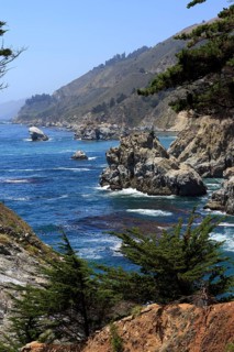 A rocky coast with trees falls steeply into the foamy sea, Big Sur Pfeiffer, US 1, North America,