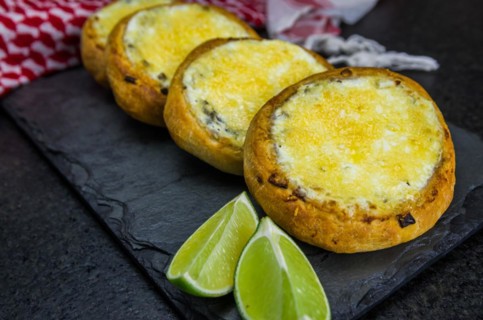Delicious Lebanese (Arabic) food, sfiha au gratin with labneh and cheese on black slate stone