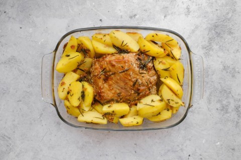 Top view of baked pork fillet with potato wedges