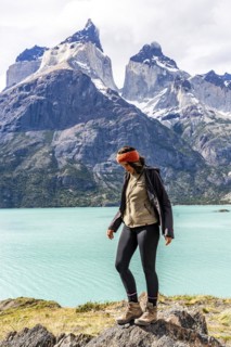 Young woman in front of Nordenskjold Lake and the Paine Mountain Range, Torres de Paine, Magallanes