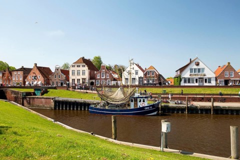 Picturesque cutter harbour, Greetsiel, ebikes, gabled houses, Krummhoern, East Frisia, Germany,