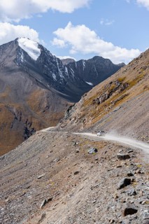Off-road car on mountain pass, gravel road in the mountains in the Tien Shan, Engilchek Valley,