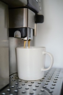 Closeup of espresso pouring from coffee machine