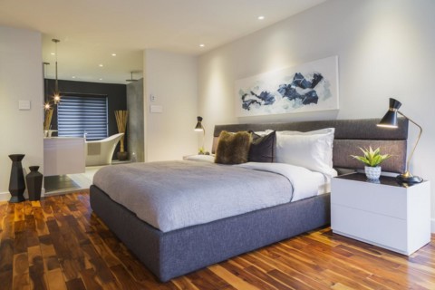 King size bed with grey fabric upholstered headboard and bed frame, white lacquered high-gloss with
