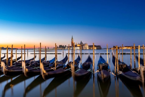Venetian gondolas, boat dock at St Mark's Square, church of San Giorgio Maggiore in the background,