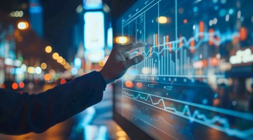 A man is pointing at a graph on a transparent screen showing market and economy trends, AI