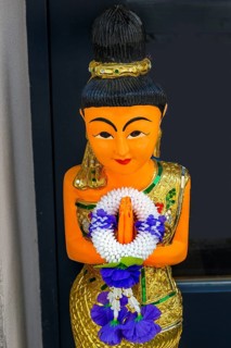 Figure with wreath of flowers at the entrance to the Thai massage parlour, Kaufbeuern, Allgaeu,