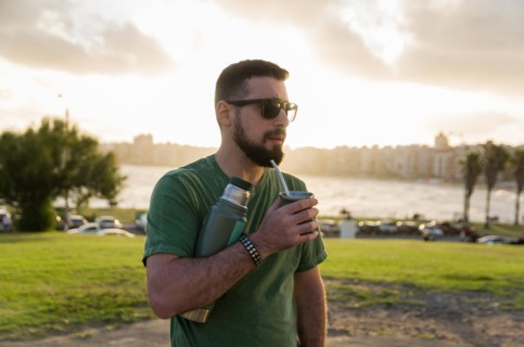 Man drinking chimarrao, mate tea tea (an infusion of yerba mate tea tea with hot water) at sunset