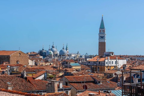 View over the roofs of Venice to the Campanile bell tower and the domes of St Mark's Basilica, view
