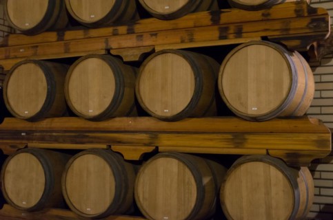 Oak barrels for wine aging in an underground cellar in Vale dos Vinhedos