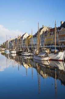 Moored sailboats and colourful 17th century apartment buildings and houses along the Nyhavn canal,