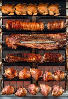 Flame wall grill with chicken possibly Turkey, ribs, pork knuckle in the marquee at the spring