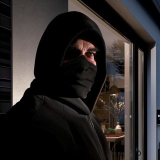 Close-up of a burglar with covered face at night in front of a window, burglary, burglar, burglary,