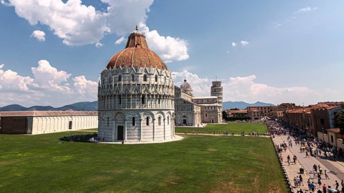 A sunny view of Piazza dei Miracoli in Pisa with the Battistero and the Cathedral of Santa Maria