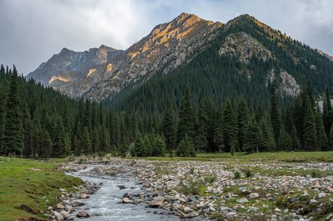 Green mountain valley with river and steep mountain peaks, Chong Kyzyl Suu Valley, Terskey Ala Too,