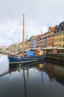 Moored sailboats and colourful 17th century apartment buildings and houses along the Nyhavn canal,