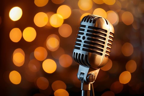 Microphone on a microphone stand with a blurry coloful background, AI generated