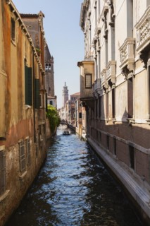Narrow canal with Renaissance architectural style residential palace buildings, footbridge and