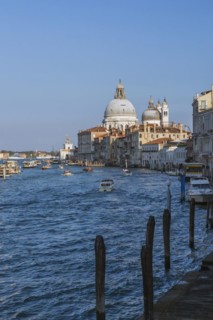 Grand Canal with water taxis, vaporettos and Santa Maria della Salute basilica in Dorsoduro