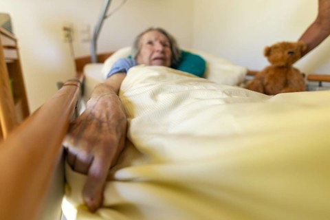 Senior citizen with dementia lying in her room in a retirement home, portrait, Baden-Wuerttemberg,