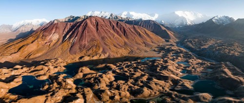 Aerial view, high mountain landscape with glacial moraines and mountain lakes, behind Pik Lenin,