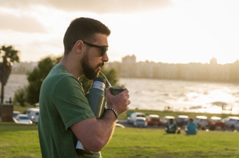 Man drinking chimarrao, mate tea tea (an infusion of yerba mate tea tea with hot water) at sunset