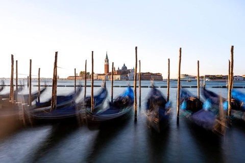 Venetian gondolas, boat dock at St Mark's Square, church of San Giorgio Maggiore in the background,