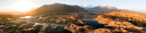 Aerial view, high mountain landscape with glacial moraines and mountain lakes, behind Pik Lenin,