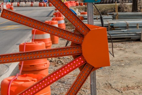 Fan shaped LED construction warning light on rural roadside next to construction site in South