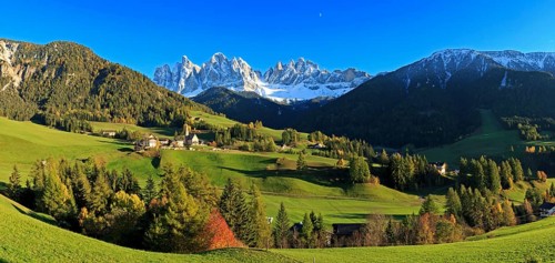 Wide panorama of an alpine landscape with meadows and scattered houses, Italy, Trentino-Alto Adige,