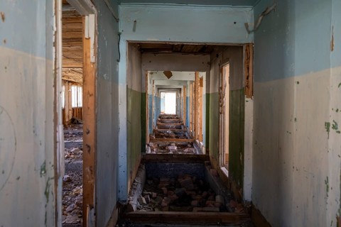 Destroyed abandoned corridor of the old Soviet school, ghost town, Engilchek, Tian Shan,